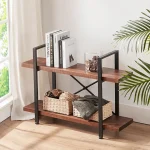 The Bookshelf, made of wood and metal with two tiers, holds books, decor, baskets, and blankets; placed by a window and plant, it’s ideal storage furniture for any cozy space.