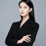 A woman with long black hair wearing a Toptrue black blazer stands with arms crossed against a plain gray background.
