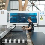 A worker in a mask operates a KDT Drill Tech machine, handling Coated Fiberboard Furniture 10 panels for OEM and ODM production in the factory.