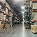 The Inventory Management 5 solution suits large warehouses with tall metal shelves, stacked boxes, and pallets—ideal for ODM/OEM needs—enabling efficient handling in long aisle spaces under high ceilings with industrial lighting.