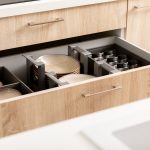 Open kitchen drawer “abcdhe-1” with organized compartments for plates, cups, and glasses in a modern wood cabinet—perfect for ODM and OEM customization.
