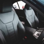 Interior view of abcdhe-5 featuring two black leather front seats, center console, and part of the steering wheel—perfect for ODM and OEM customization.