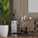 Modern living room with a potted plant, round coffee tables, a vase with flowers, a teapot set, and decorative sculptures on a wooden cabinet against a neutral-colored wall.