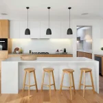 The r-architecture-TRCJ-87Yoh0-unsplash features modern white cabinetry, wood accents, a marble island with four wooden stools, black pendant lights, and built-in appliances—ideal for both ODM and OEM projects.
