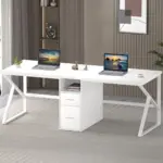 The 01.01.C1_结果 is a white L-shaped desk featuring two open laptops, a small plant, two drawers, and décor in a modern carpeted office—ideal for ODM or OEM business setups.