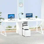 The 02.01.C1_结果 is a modern white double desk with two desktop computers, a lamp, and center drawers—ideal for ODM or OEM office setups—in a bright room with large windows and a wall clock.