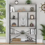 The 02.01.C_结果 is a modern OEM bookshelf with five shelves, showcasing books, sculptures, a clock, potted plants, and figurines. Nearby, a window and plant add to the contemporary display.