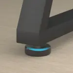 A close-up of the 07.01.C_结果 black furniture leg on a round, black and blue adjustable leveling foot, ideal for OEM or ODM needs, displayed on a light wood floor.