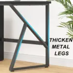 A close-up of 08.01.C_结果, a desk featuring thick geometric black metal legs ready for OEM/ODM customization, with the text "THICKEN METAL LEGS" and a partially visible plant on the right.