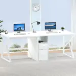 The 09.01.C_结果 is a modern white OEM desk featuring two desktop computers, a lamp, small plants, and drawers, positioned in front of large windows in a bright room.
