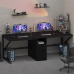 A modern dual-monitor gaming setup features two desktops, accessories, LED lights, and figurines on a black L-shaped desk—ideal for highlighting 10.01.C_结果 OEM and ODM gaming gear.