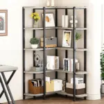 The 12.01.C 1500 1500_结果 corner shelf unit with five tiers showcases books, photos, vases, plants, and storage boxes against a light-colored wall in a home office.