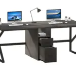 Two 14.01.C1_结果 black L-shaped desks joined at the center with drawers, each holding a computer setup and plants—perfect for ODM or OEM workspace customization.