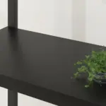 A 6 Tier Bookshelf, Black Oak_03 with a small green potted plant on the right side, set against a white wall.