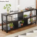 The 7_结果, a black rectangular display shelf for OEM and ODM, showcases books, plants, a lamp, turntable, and decor in a bright room with wooden floors and large windows.