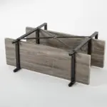 The BC02-01 04 - 03 2-Shelf Rustic Industrial Bookshelf, featuring wood shelves and a metal frame, is displayed upside down on a white surface to showcase its underside and support structure—perfect for ODM or OEM customization.