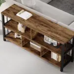 The 俯视_结果 wooden console table with a black metal frame, suitable for OEM and ODM orders, stands behind a sofa in a modern living room, displaying books and decor on its shelves.