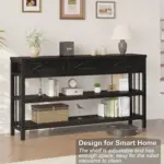 The Sofa Table with 3 Drawers in Black Oak stands against the wall, displaying books, baskets, and decor. Features include an adjustable shelf, robot vacuum clearance, and versatile use as a sofa table.