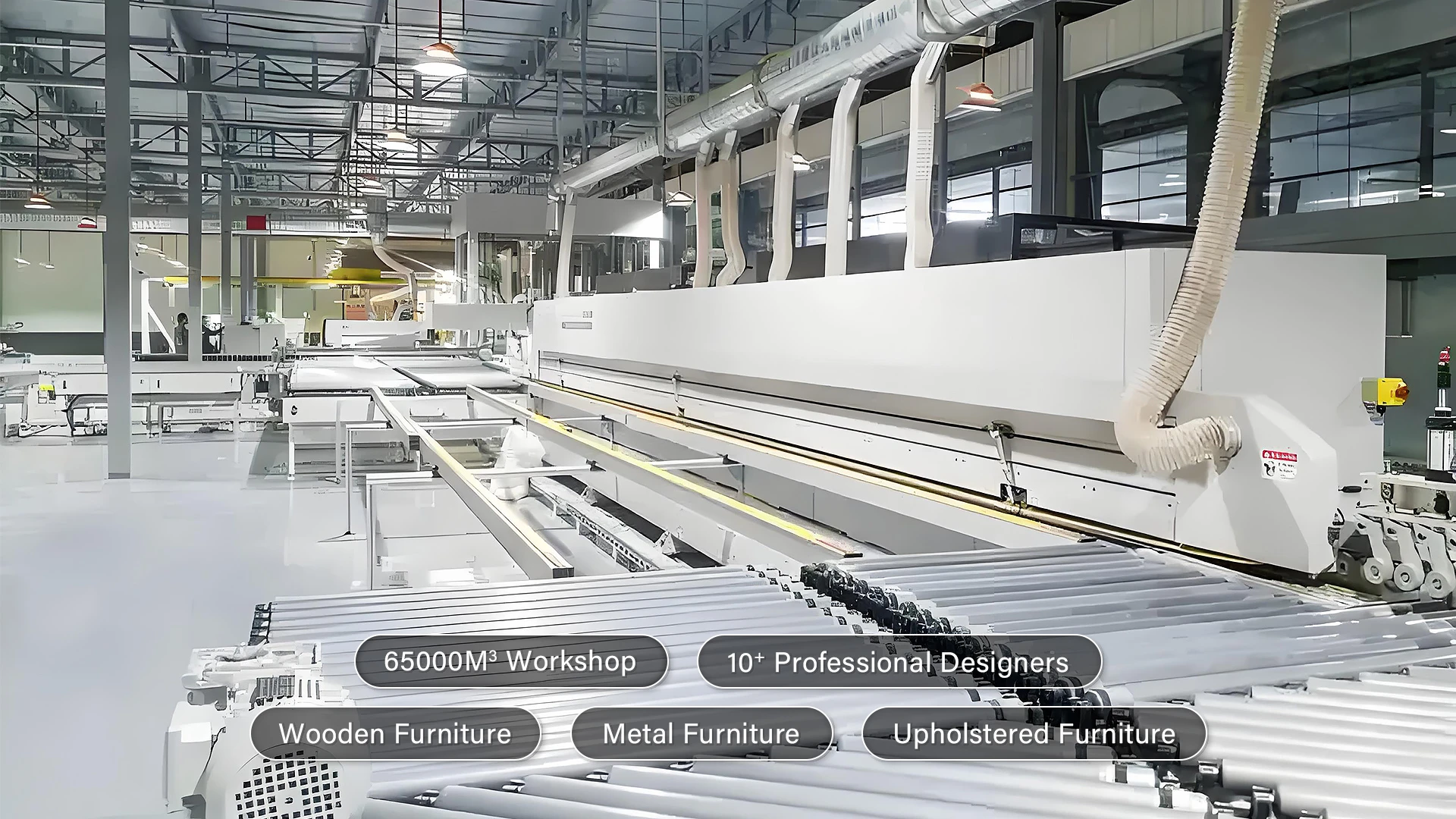 Large, modern factory workshop with industrial machines and conveyor rollers; on-screen text highlights the workshop size, number of designers, and various furniture production types.